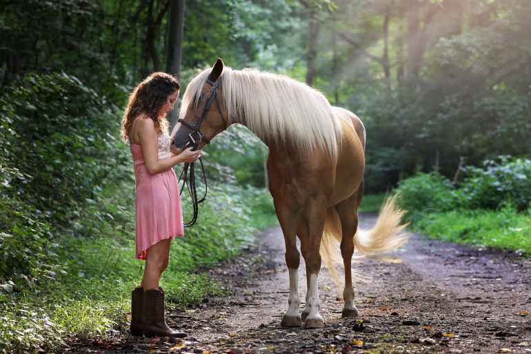 woman affectionate with horse